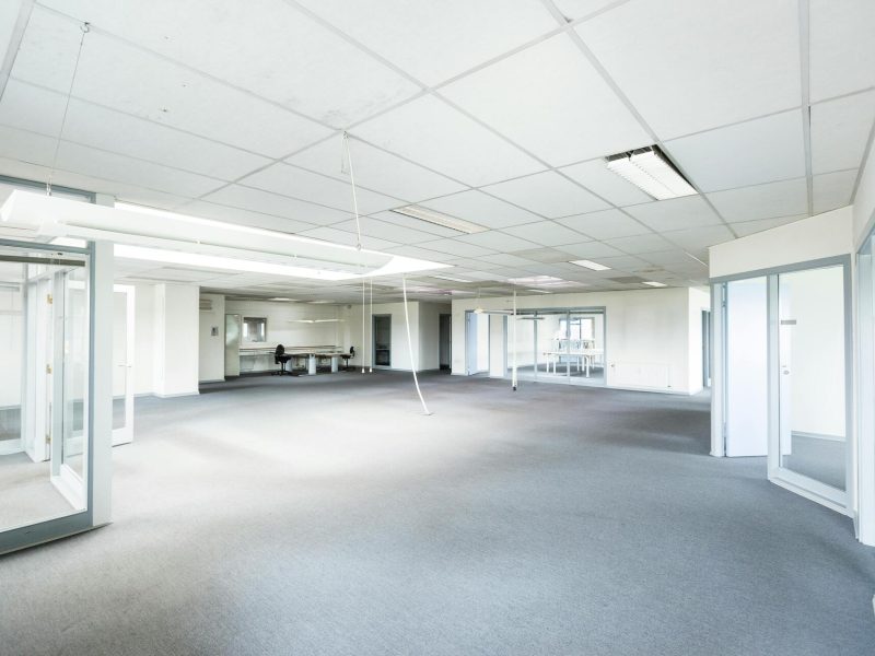 bright-empty-office-space-featuring-minimalist-design-and-glass-partitions-tzNcI3FmNElQ2PxvfWzSjw